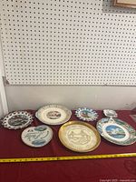 Front view showing six decorative plates on table