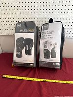 Both Everlast glove sets in packaging on table