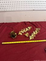 Two garland strands and clustered leaf piece with tape measure for scale