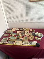 Overview of entire lot on table showing postcards and photographs