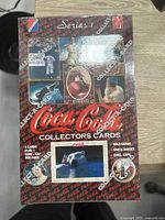 Front view of the sealed 1993 Coca-Cola Series 1 Collectors Cards box showing branding, card count, and vintage ad images.