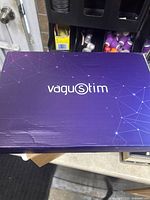 Image of the Vagustim device box top, purple with the Vagustim logo in white.