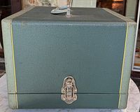 Front view of closed textured carrying case with latch