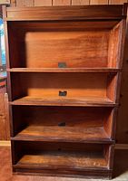 Front view showing four shelf boxes stacked between base and top