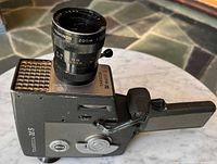 Left side view showing model markings, zoom lens, controls