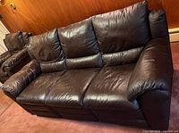 Front view of brown leather reclining couch