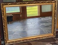 Full view of rectangular gold-framed mirror