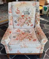Front view of floral high-back armchair showing upholstery pattern and seat cushion