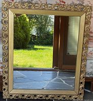 Front view of rectangular gold ornate mirror