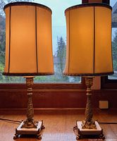 Front view of both lamps showing shades, bronze columns and marble bases