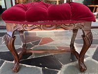 Side view showing carved frame, tufted cushion