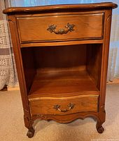 Front view showing drawers, open shelf, hardware, legs