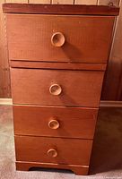 Front view showing four drawers and knobs