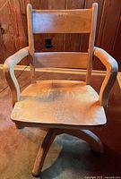 Front view showing seat, arms, and base