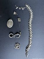 All jewelry pieces displayed together on black background, showing size and variety of lot