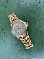 Full view of watch on green surface