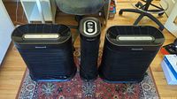 Front view of three Honeywell air purifiers on rug