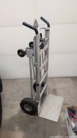 Full view of aluminum hand truck dolly folded upright