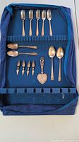 Open velvet case showing all flatware pieces arranged