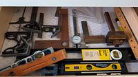 Drawer view showing assorted squares, levels, gauges, dial indicator and rulers