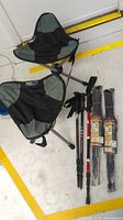 Overall view: two TravelChair tripod camp chairs, three loose trekking poles, two packaged Stansport poles
