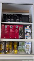 Shelved lot showing Defiant timers, GE bulbs, net lights, Philips bulbs, yellow bug bulbs