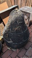 Stack of nested chicken wire cloches with extensions
