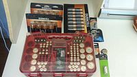 Wide view showing packaged Duracell batteries, specialty cells, and red Battery Daddy organizer