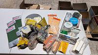 Top-down view showing entire assortment of abrasive pads, steel wool, buffing sticks, touch-up sticks, tins and creams