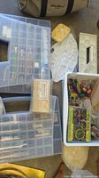 overview showing multiple clear organizers, palettes, beeswax block, white bin with thread
