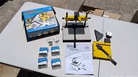 Complete lot laid out on table: joiner base, lever accessory, wedge packs, manual, box