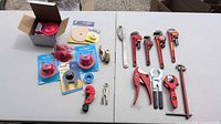 Overview of all plumbing tools and parts laid on table
