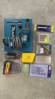 Makita drill, case, and all drill bit sets laid out