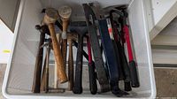 Drawer basket showing entire assortment of hammers, mallets, pry bars, bolt cutters