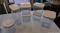 Seven OXO POP containers grouped on table