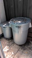 Two of the BRUTE trash cans showing size difference and lids