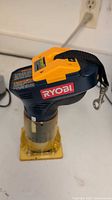 Top view of Ryobi cordless trim router with battery attached