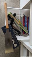 Drawer containing Japanese pull saw, hacksaw frames, blade packs