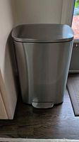 Front view of stainless steel trash can
