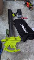 Vacuum/blower with tube, battery on charger, collection bag