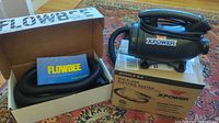 XPower duster on its box next to boxed Flowbee hose kit