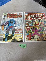 Front covers of both comic books in sleeves