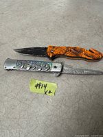 Both knives open showing blades and handles