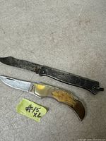 Both knives open to show blades and handles