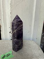 Front view of amethyst obelisk showing height and color