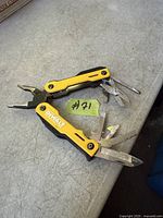 Multi-tool open showing pliers and several fold-out tools