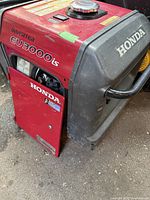 Left front view of generator showing Honda branding and open side door