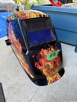 Left front profile showing flame graphics and viewing lens