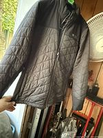 Front view of Milwaukee quilted jacket on hanger
