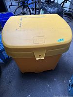 Front view of yellow FCMP storage bin showing overall condition and size